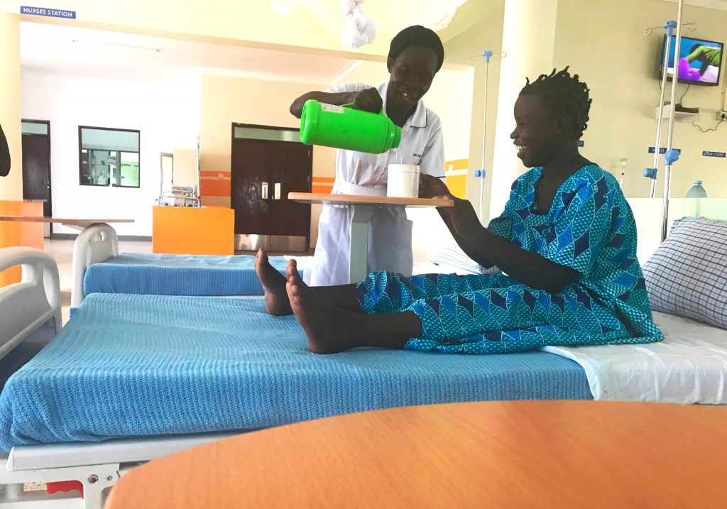 A nurse serves a a recovering survivor at TWCH. The specialised fistula hospital renders holistic fistula care.