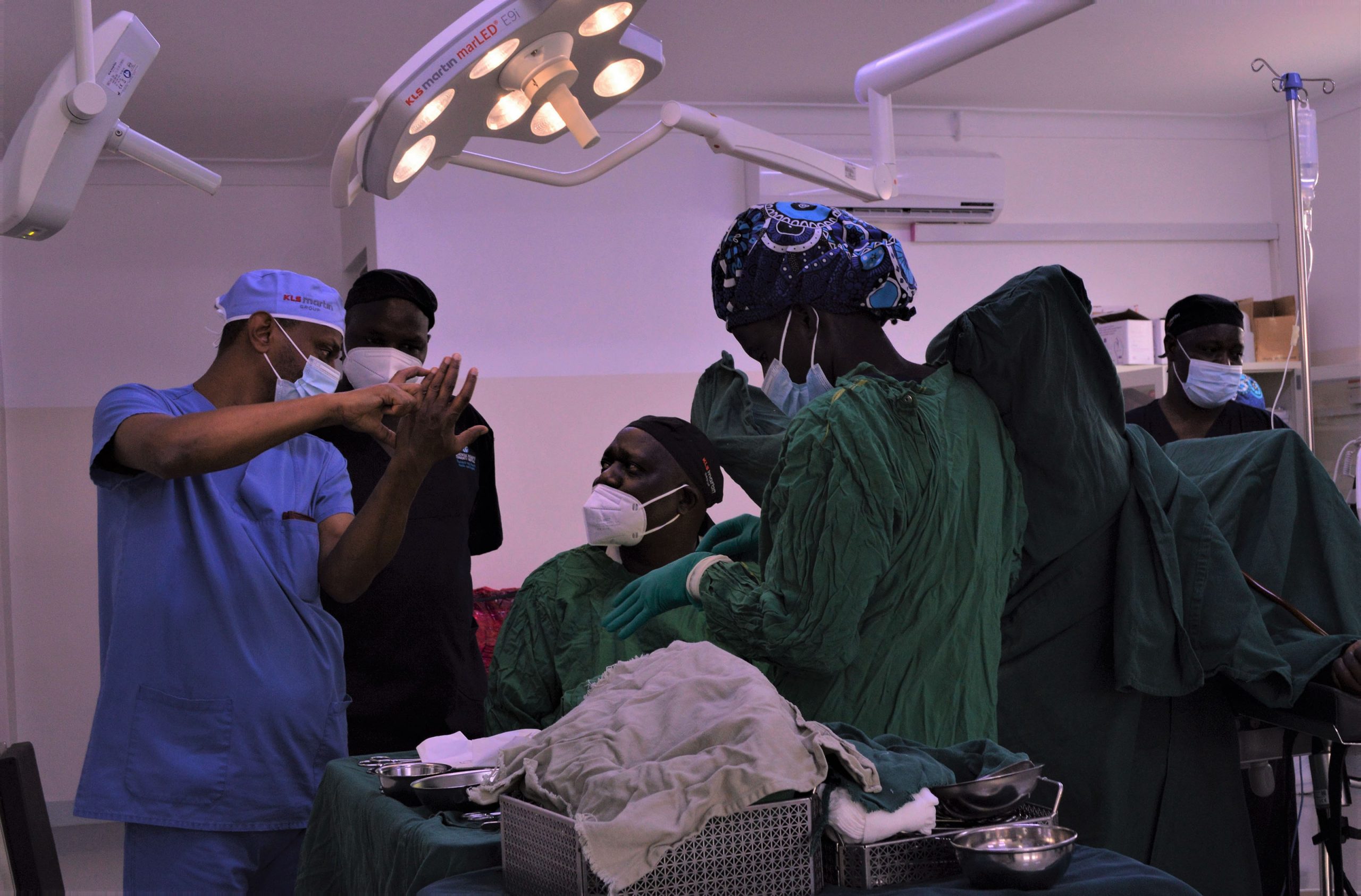 Dr. Fekade Ayenachew (Left), the lead trainer shares techniques with other surgeons in theatre during a surgery in theatre
